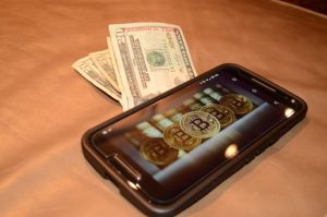 bitcoin on phone and money